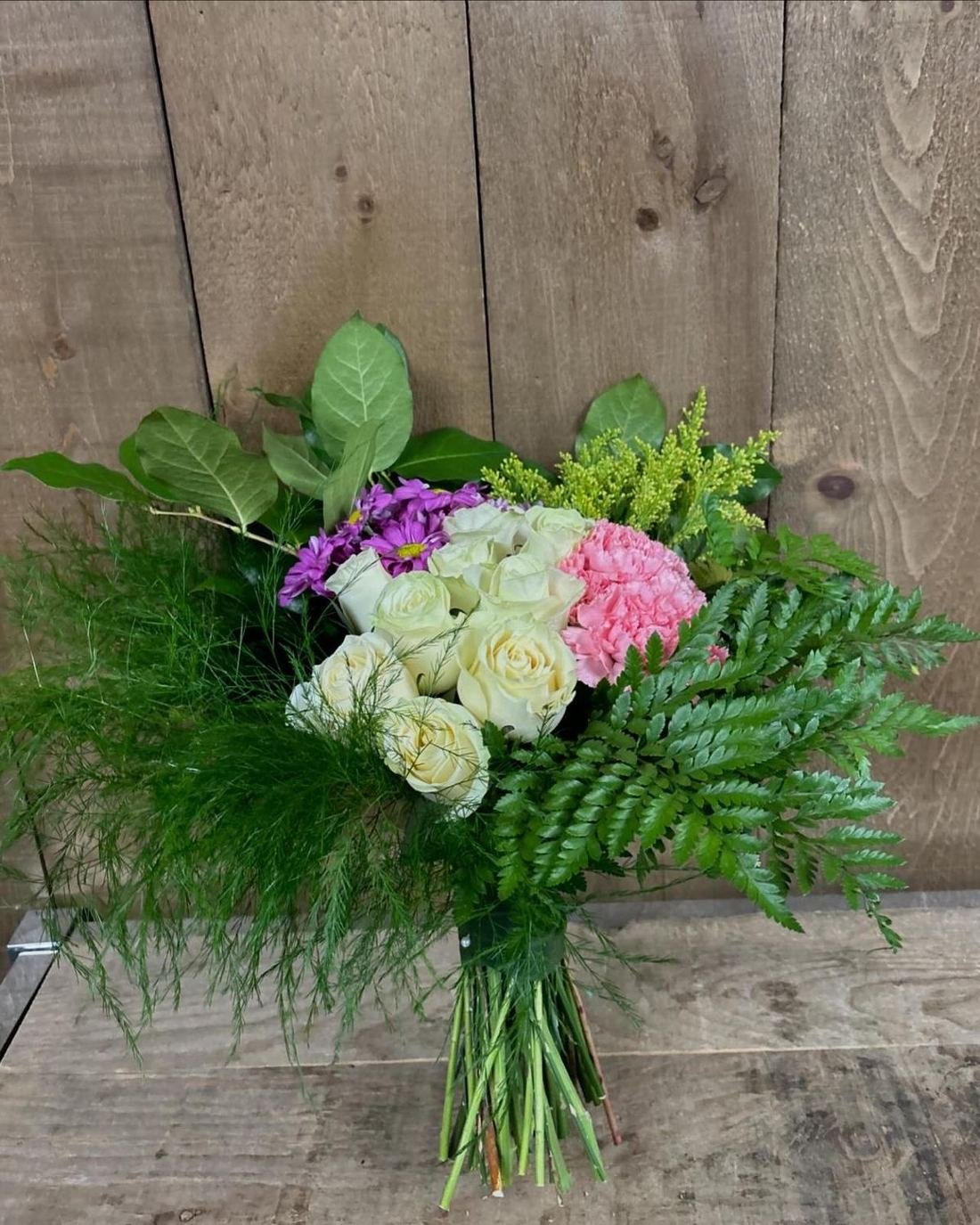 Hand-tied bouquet of ivory roses and ferns