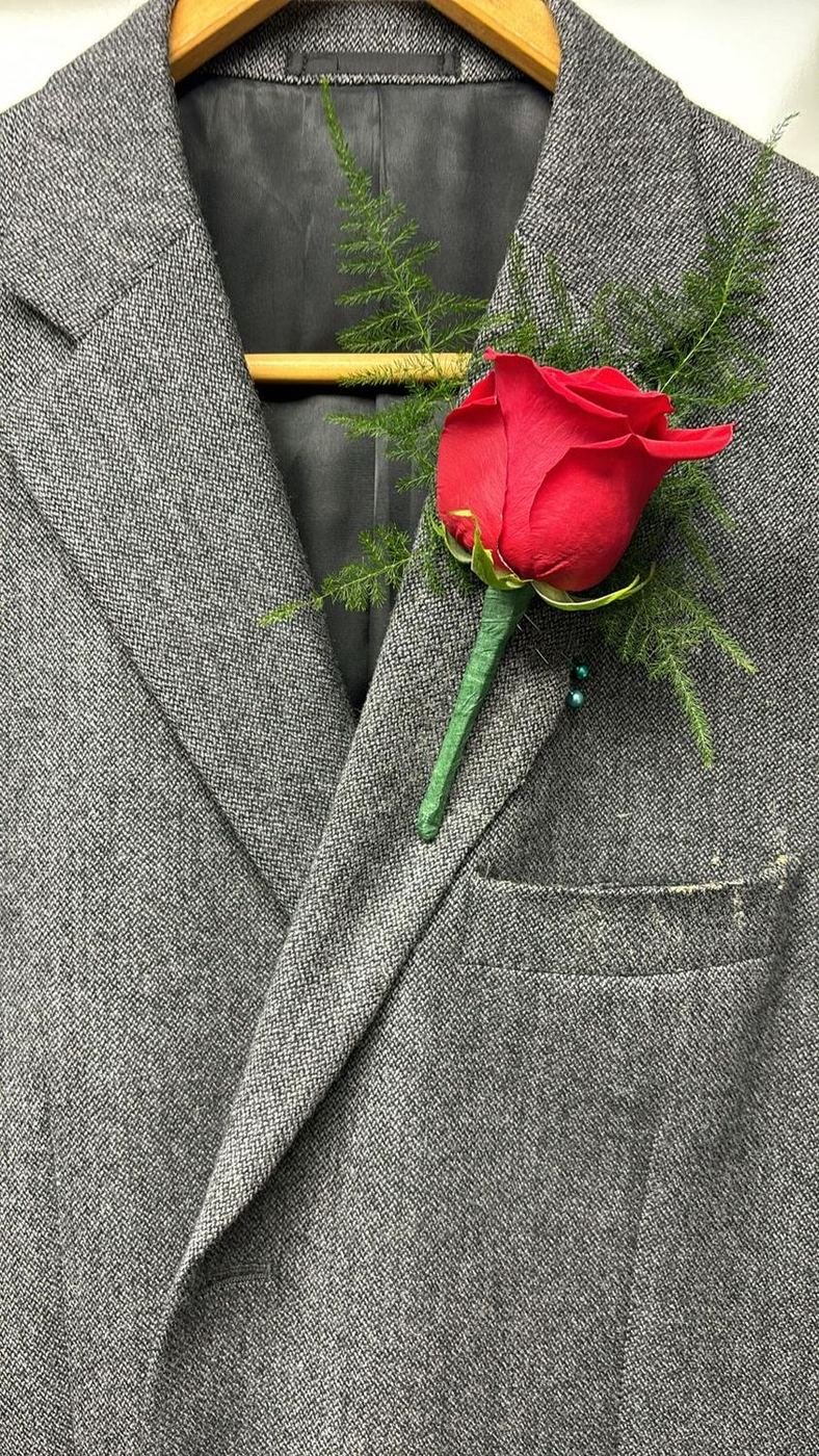 Classic red rose boutonnière with asparagus fern
