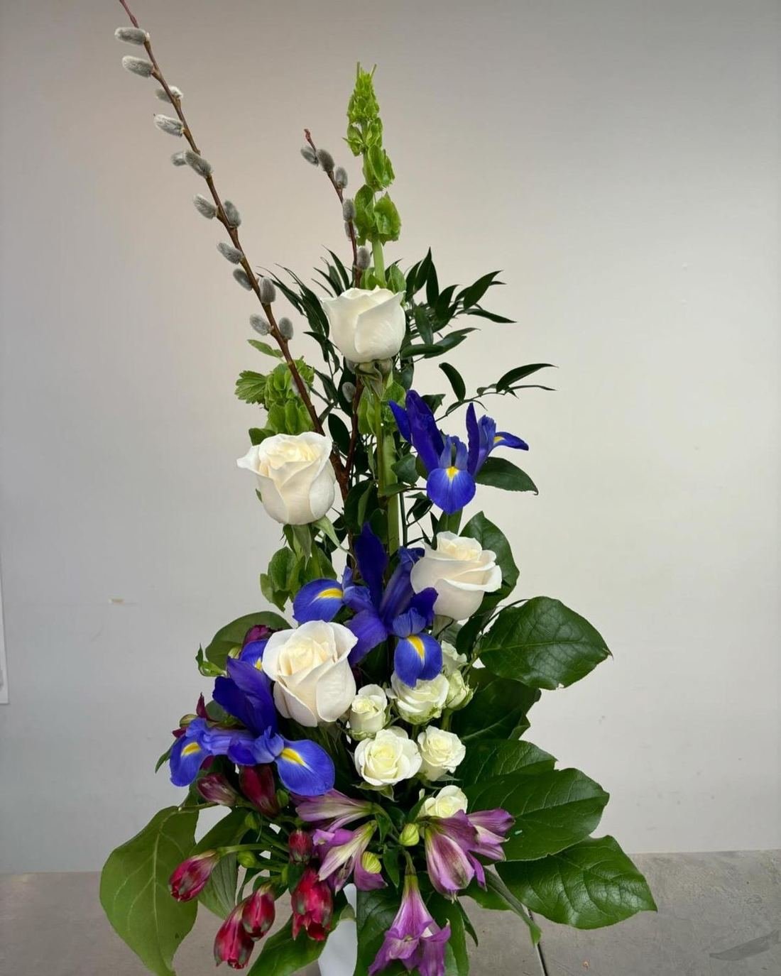 Ivory roses and blue iris arrangement