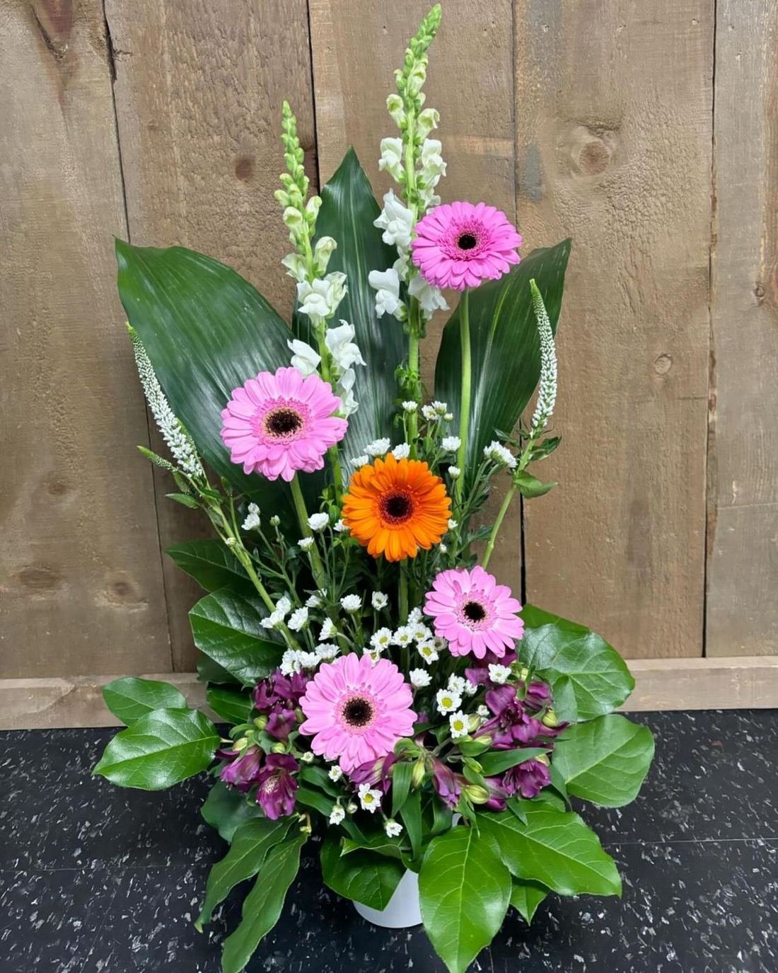 Pink and orange gerbera arrangement with snapdragons