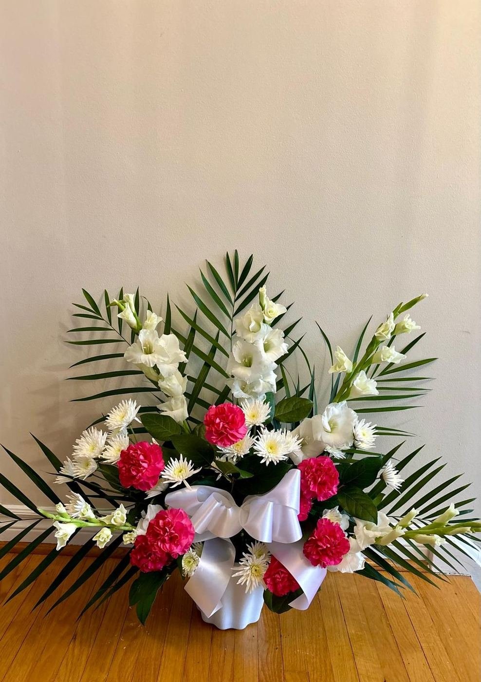 White gladiolus and pink carnation sympathy arrangement